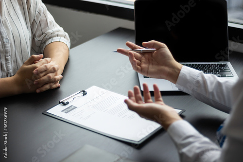 A female job applicant attending a job interview with a HR manager for an accounting position at a company, HR manager reviewing a job applicant's resume, job interview ideas and recruiting.