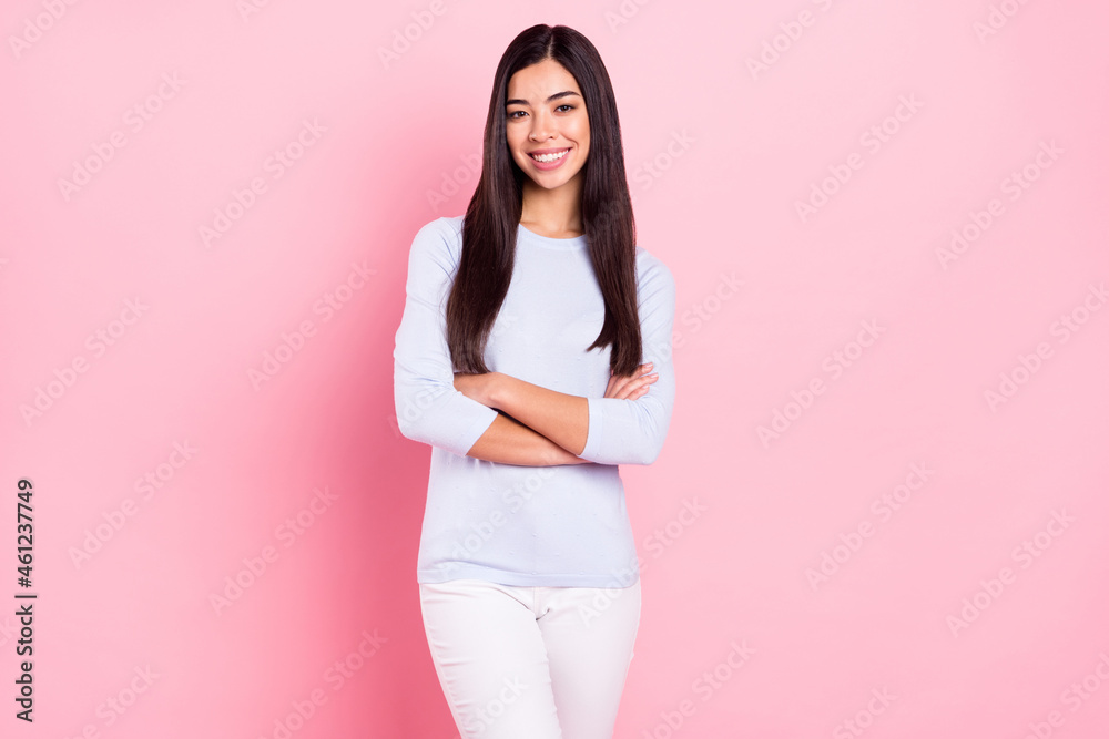 Photo portrait of girl with folded hands in blue shirt smiling happy successful freelancer isolated on pastel pink color background Photo portrait of girl with folded hands in blue shirt smiling happy successful freelancer isolated on pastel pink color background
