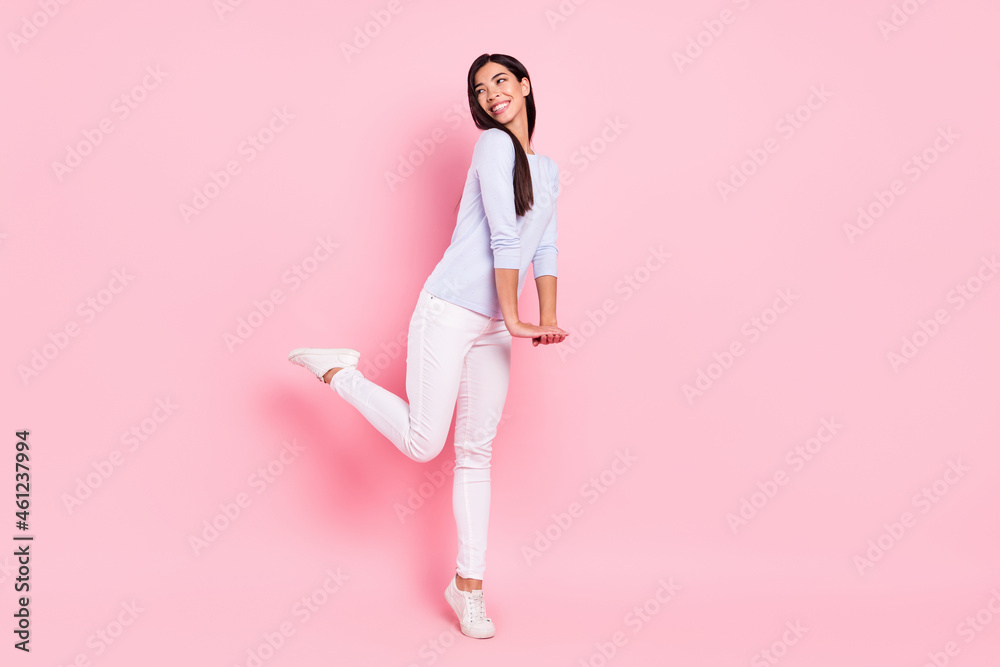 Full length body size view of attractive shy modest cheerful girl dancing having fun posing isolated over pink pastel color background Full length body size view of attractive shy modest cheerful girl dancing having fun posing isolated over pink pastel color background