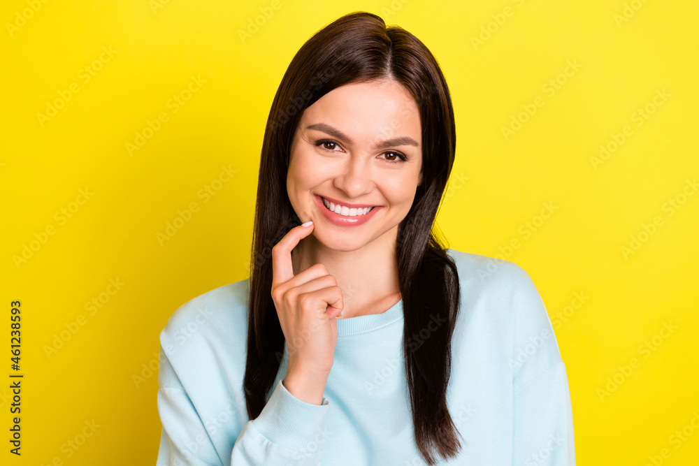 Portrait of attractive bewildered cheerful girl deciding touching chin isolated over bright yellow color background Portrait of attractive bewildered cheerful girl deciding touching chin isolated over bright yellow color background