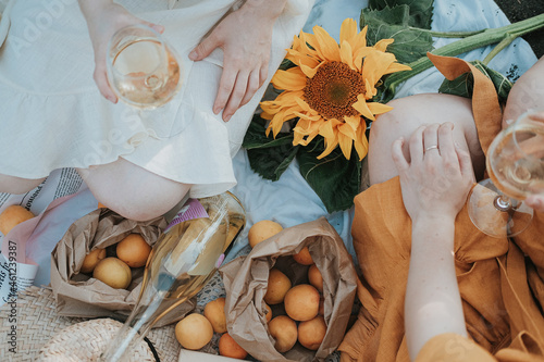 picnic with wine in a field with sunflowers . summer photo