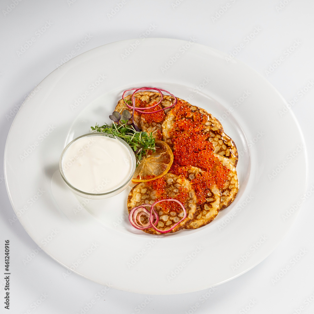 Delicious pancakes with red caviar. Russian and Ukrainian cuisine. The concept of the Maslenitsa holiday. Delicious pancakes with red caviar. Russian and Ukrainian cuisine. The concept of the Maslenitsa holiday.