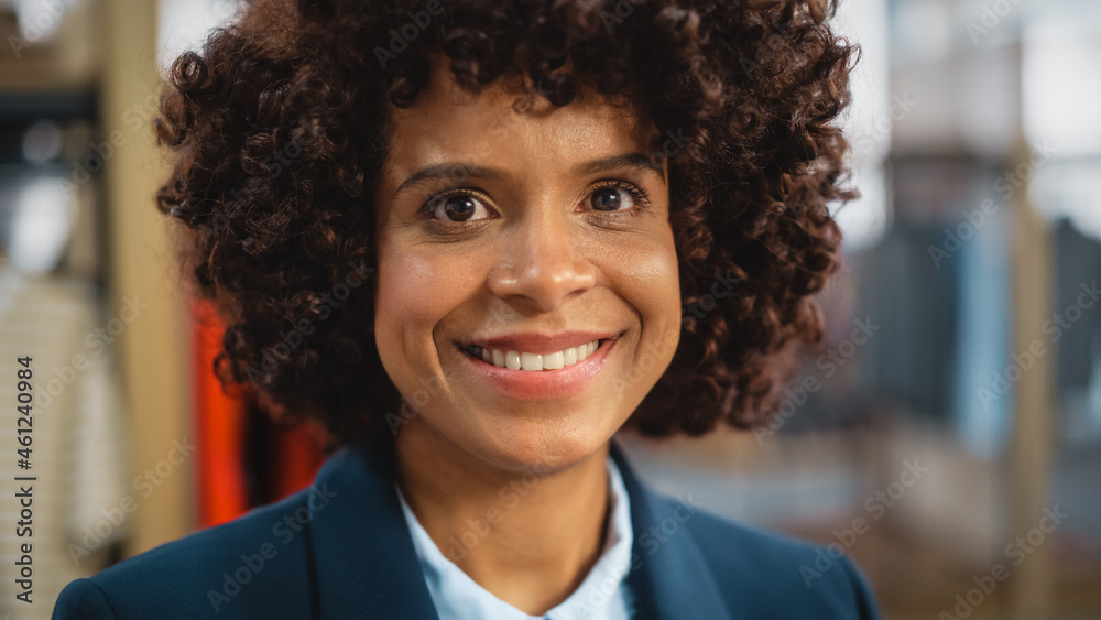 Portrait of a Happy Black Female with Stylish Afro Hair Smiling and Posing for Camera at Clothing Store. Small Business Owner in a Role of a Diverse Businesswoman or Sales Manager. - obrazy, fototapety, plakaty 