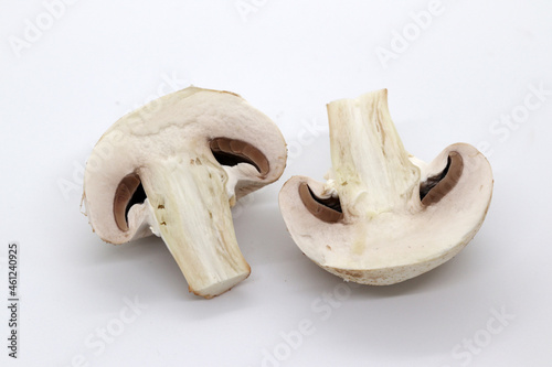 two cut halves of a champignon mushroom lie side by side