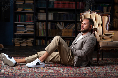 Handsome man in library. Hair style, beard, suit, fashion style