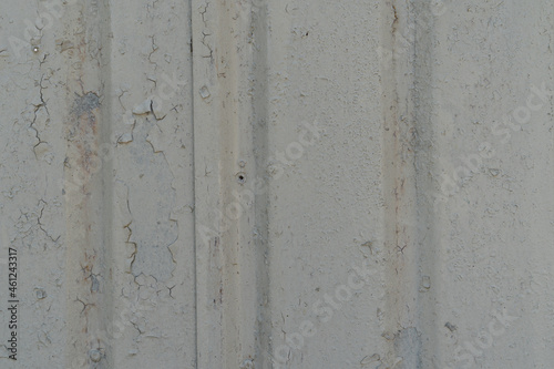 Garage corrosion on a rough striped metal wall or floor, scratches, air holes, rusty house fence, holes, dents, pins.