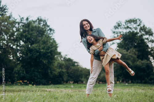 Mother with her daughter having fun together in park