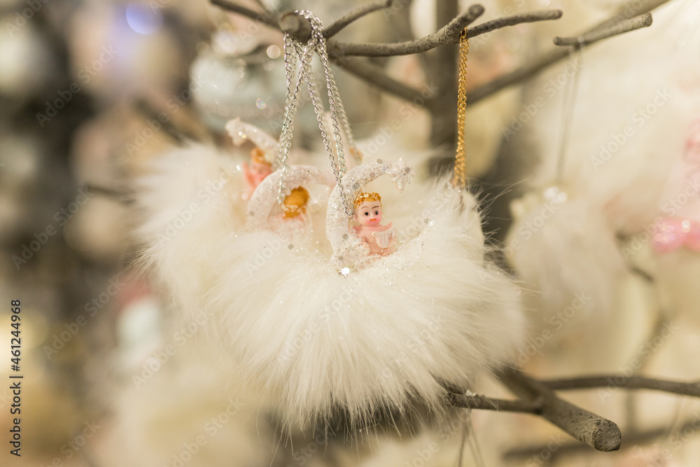 Close up of Christmas location with white angels toys on the branch Close up of Christmas location with white angels toys on the branch