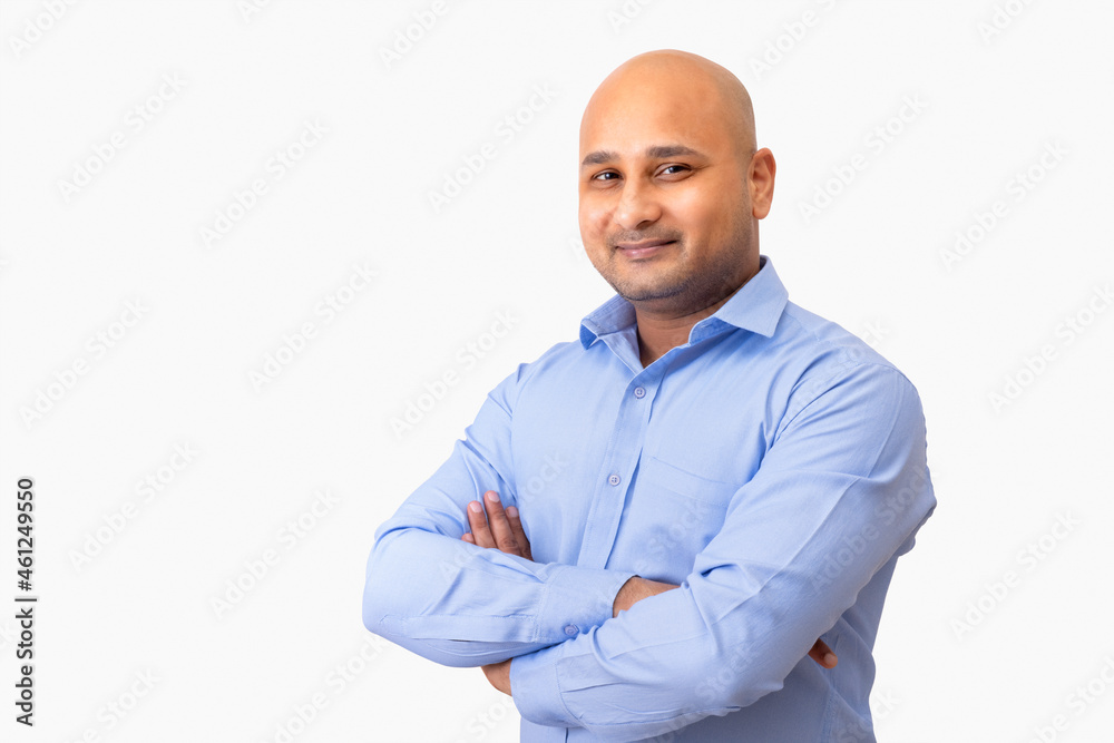 Portrait of a bald man in formal clothing smiling with cross arms against white background. Portrait of a bald man in formal clothing smiling with cross arms against white background.