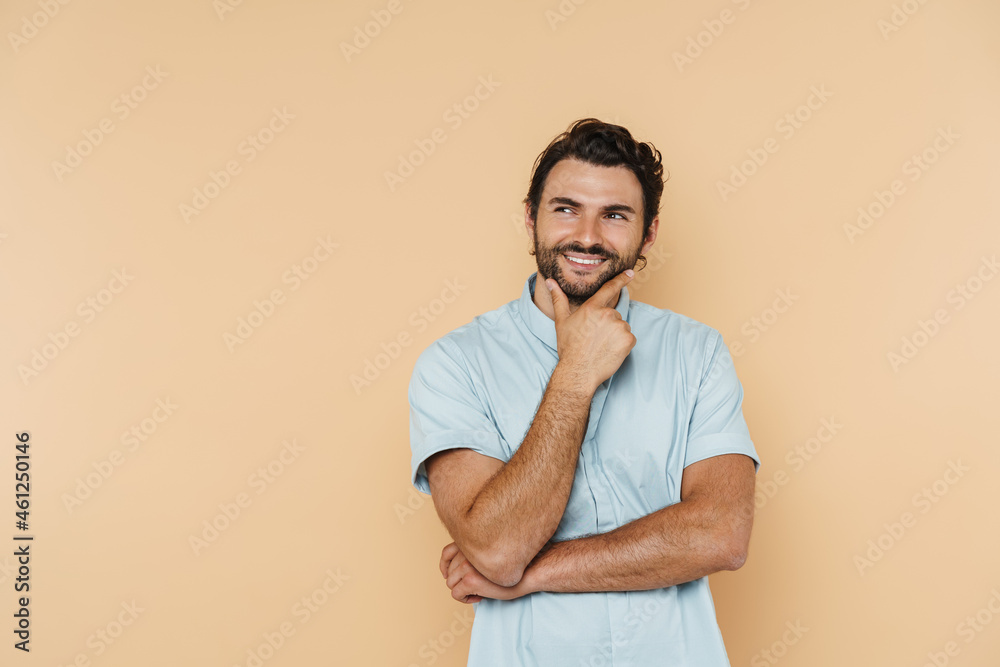 Young white man wearing shirt smiling and looking aside Young white man wearing shirt smiling and looking aside