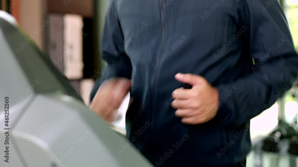 Young athlete running on the treadmill. Close up male runner exercise indoor gym. fitness man jogging wearing sportswear. Workout and healthy Young athlete running on the treadmill. Close up male runner exercise indoor gym. fitness man jogging wearing sportswear. Workout and healthy