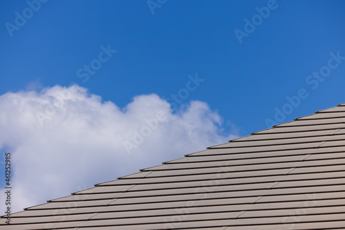 屋根と青空の雲のシンプルな構図