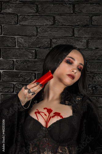 Tableau sur toile a girl with long hair in the image of a witch is trying to set herself on fire