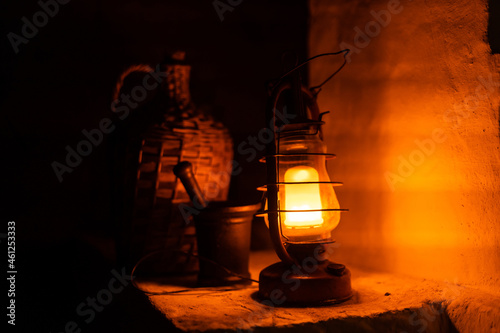 Old fashioned lantern in darkness. Light concept.