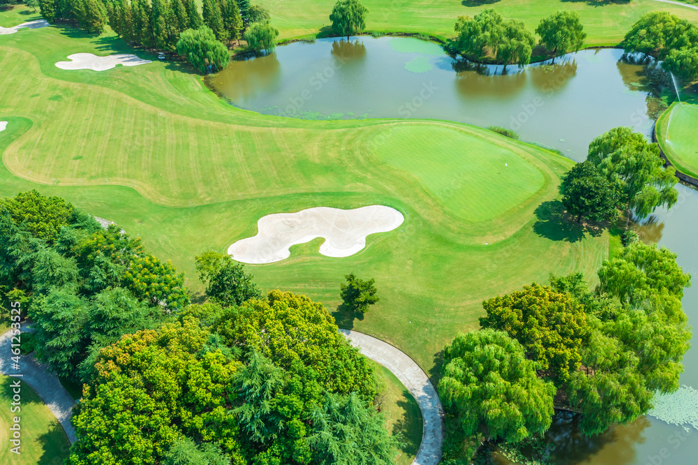 Aerial view of green lawn and forest on golf course. Aerial view of green lawn and forest on golf course.