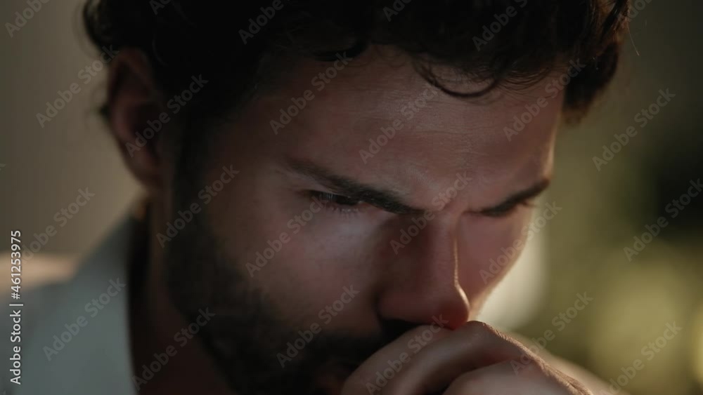 A close-up view of the face tired man working in the office at night A close-up view of the face tired man working in the office at night