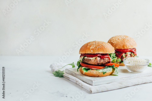 close-up of two burgers on a white background