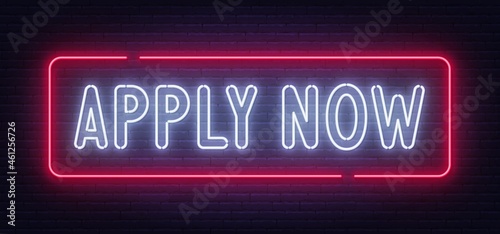 Apply Now neon sign on a brick wall background.