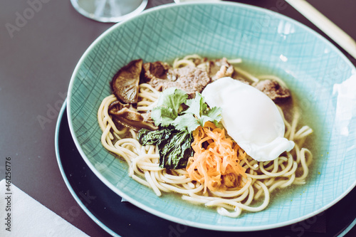 Beef ramen soup with poached egg and vegetables at a restaurant