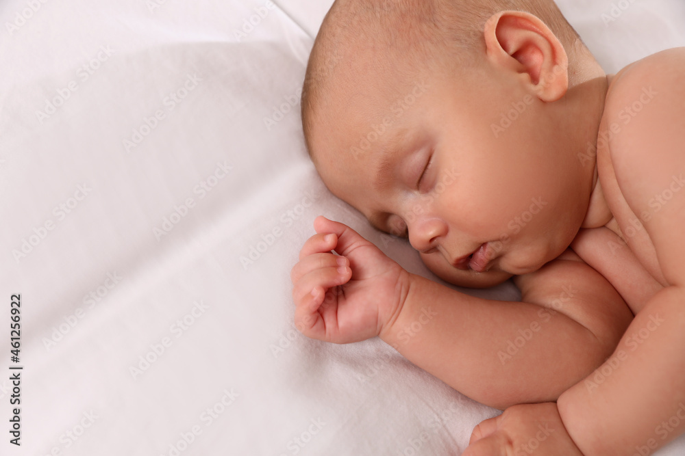 Cute little baby sleeping on bed, above view. Space for text Cute little baby sleeping on bed, above view. Space for text