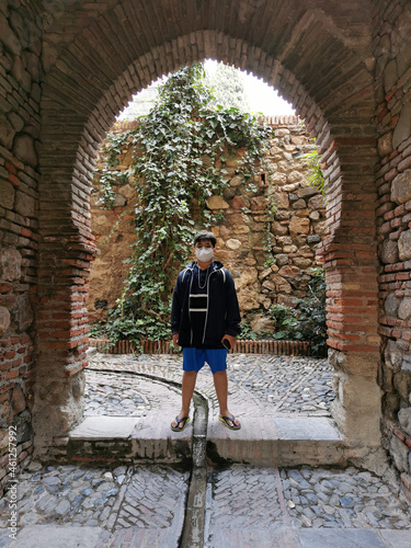 Boy under a beautiful Moorish arch