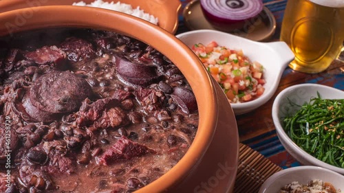 Typical Brazilian dish called Feijoada. Slide shot with smoke. Top View photo