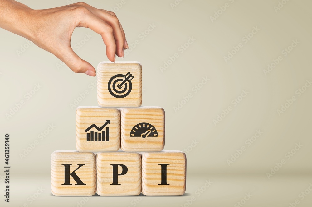 KPI, Key Performance Indicator. Wooden cube with icon; business goals, performance results KPI, Key Performance Indicator. Wooden cube with icon; business goals, performance results