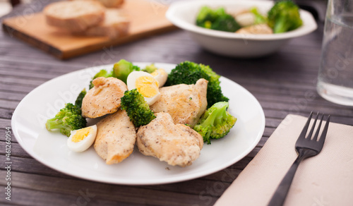 chicken breast with broccoli and quail eggs on plate for healthy dinner