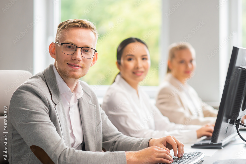 Diverse team of young professionals is working in the e-mail support center. Working day of sales managers in office. Business, consulting, and problem solving via email. Diverse team of young professionals is working in the e-mail support center. Working day of sales managers in office. Business, consulting, and problem solving via email.