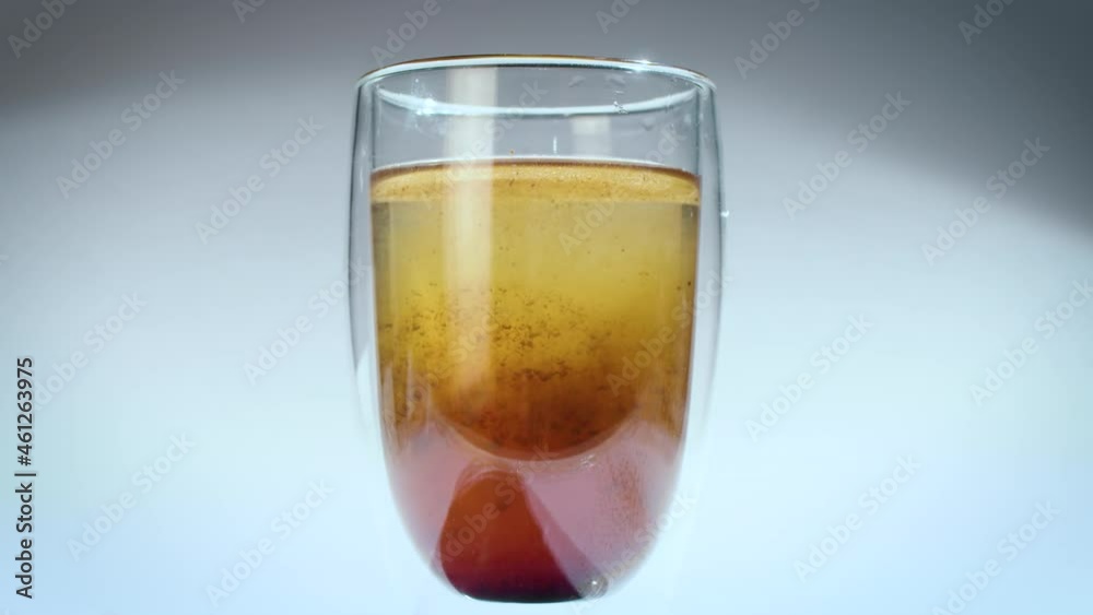 instant coffee being poured into a glass of hot water. double-walled glass. slow motion instant coffee being poured into a glass of hot water. double-walled glass. slow motion
