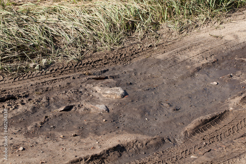 A hole in a sandy country road.