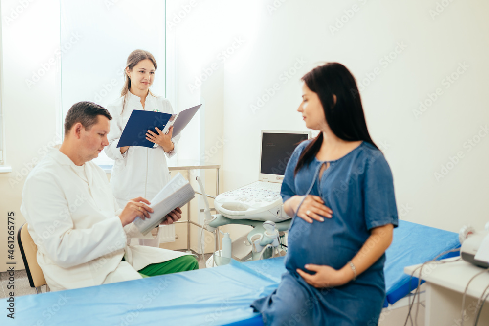 Gynecologist providing medical checkup for pregnant woman Gynecologist providing medical checkup for pregnant woman