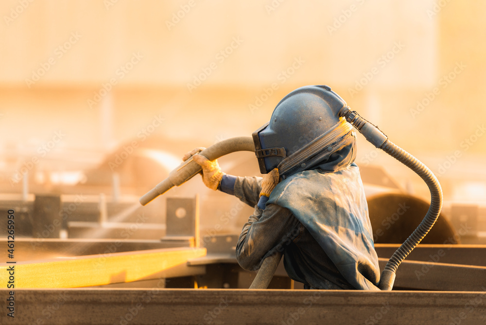 Sand blasting process, Industial worker using sand blasting process