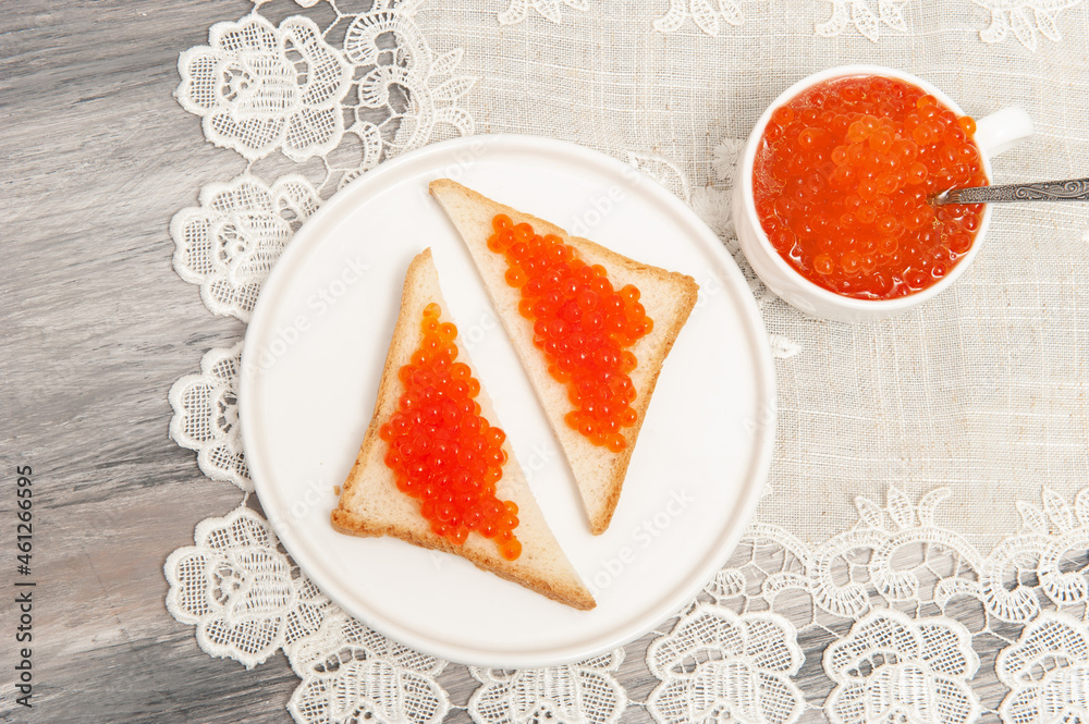 sandwiches with red caviar on a plate. top view