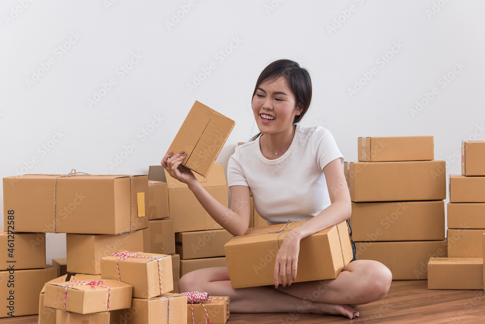 In business on line,young asia beautiful entrepreneur woman owner work and use post box,take note,prepare to send product by mail In business on line,young asia beautiful entrepreneur woman owner work and use post box,take note,prepare to send product by mail