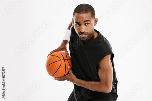 Young black sportsman playing basketball while working out © Drobot Dean