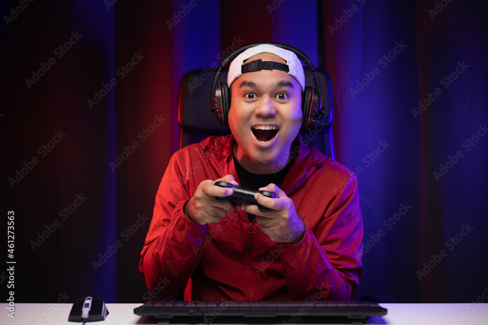 Egamer Computer Face Excited and shocked face of Asian gamer with headphone holding joystick ...