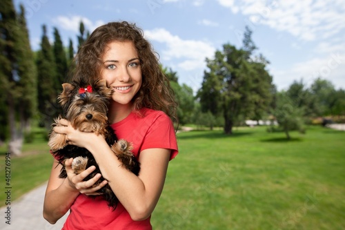 Beauty young woman holding dog on her arm smile and happiness,