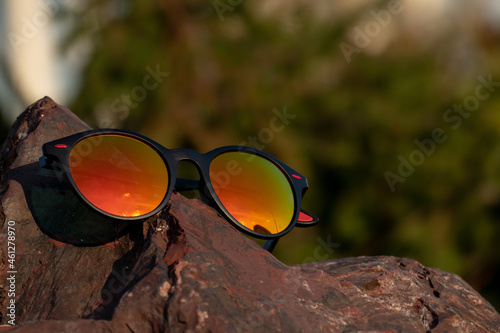 Stylish eyeglasses on rock