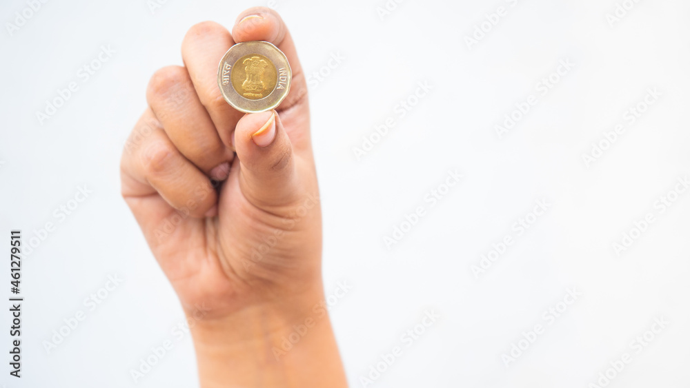 Indian girl showing head side of ten-rupee coin Indian girl showing head side of ten-rupee coin