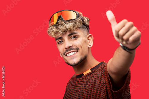 Smiling stylish man showing thumb up gesture
