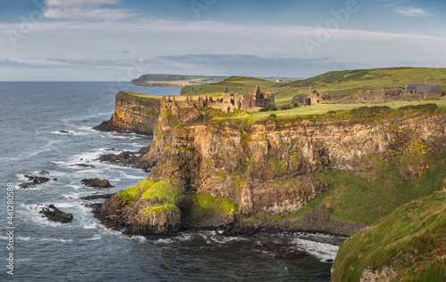 Εκτύπωση καμβά Panoramic shot of Dunluce Castle at sunset l,ocated on the edge of cliff, Bushmills, Northern Ireland