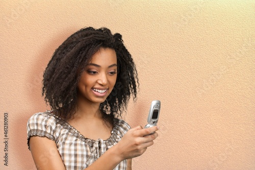 Young woman holds modern mobile phone surfs net checks newsfeed in social networks