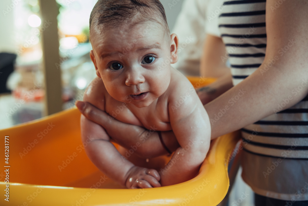 Unrecognizable Mother Holding Clean Baby Boy after Bath at Home. An