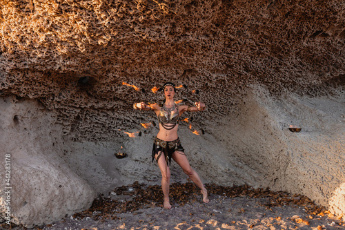 Cabo de Gata, Almeria, Spain. Female performer with fire fans on the beach rehearsing her performance.