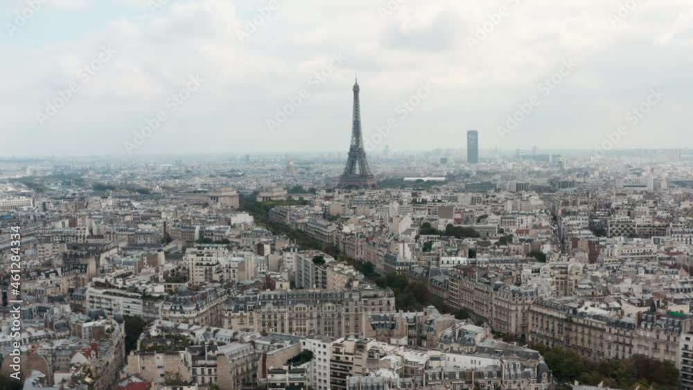 Slow dolly forward drone shot of the Eiffel Tower with classic Paris style buildings in the foreground Slow dolly forward drone shot of the Eiffel Tower with classic Paris style buildings in the foreground