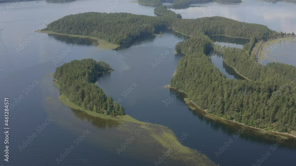 Aerial view moving right shot, scenic view of the landscape of the vuoksi river in Imatra Finland, tall pine trees in the background Aerial view moving right shot, scenic view of the landscape of the vuoksi river in Imatra Finland, tall pine trees in the background