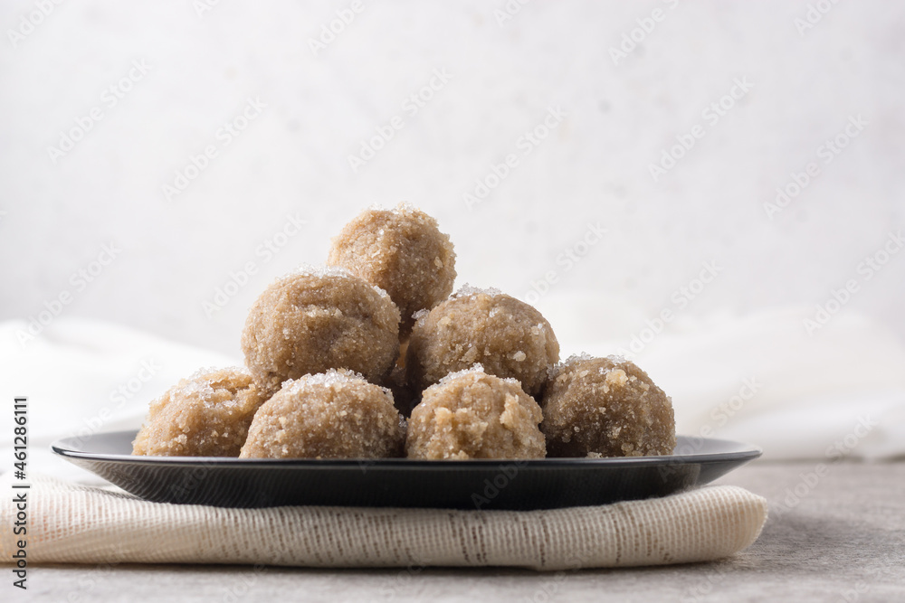 sweet snack, rice and coconut flakes balls on a plate, sugar sprinkled on top, sugary dessert or breakfast sweet snack, rice and coconut flakes balls on a plate, sugar sprinkled on top, sugary dessert or breakfast