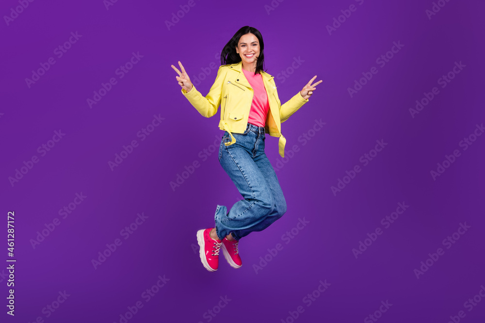 Full size profile side photo of young girl good mood jump air show victory v-symbol isolated over violet color background Full size profile side photo of young girl good mood jump air show victory v-symbol isolated over violet color background