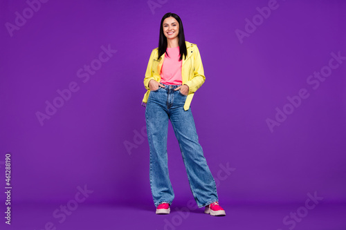 Foto Full size photo of young cheerful lady arms in pocket cool standing isolated ove